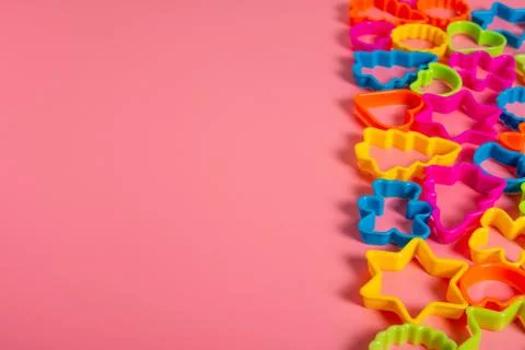 Multi-colored plastic molds of various shapes grouped on the right for making Stock Photos