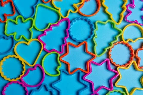Multi-colored plastic molds of various shapes for the manufacture of cookies  Stock Photos