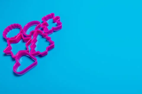 Multi-colored plastic molds of various shapes grouped on top for making cooki Stock Photos