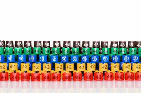 Multi-colored plastic size labels for hangers of clothing store. Stock Photos