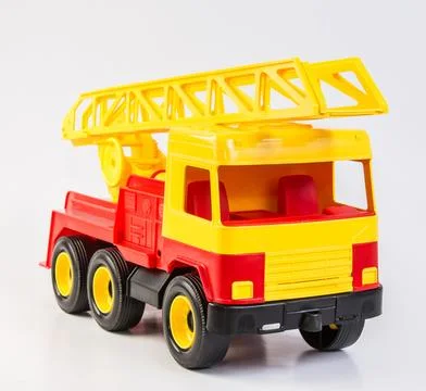 Multi-colored plastic toy trucks for children's games on a white background Fotos de archivo