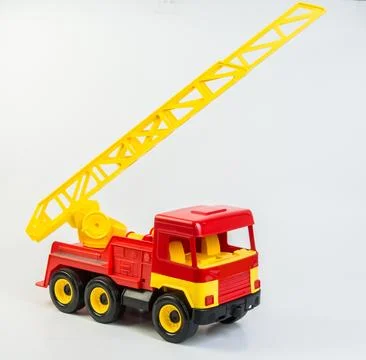 Multi-colored plastic toy trucks for children's games on a white background. Red 写真素材
