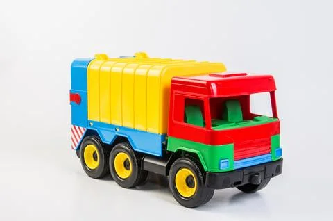 Multi-colored plastic toy trucks for children's games on a white background Fotos de archivo