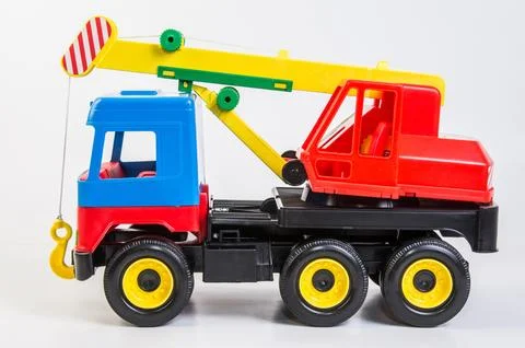 Multi-colored plastic toy trucks for children's games on a white background 写真素材