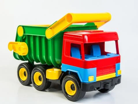 Multi-colored plastic toy trucks for children's games on a white background Foto stock