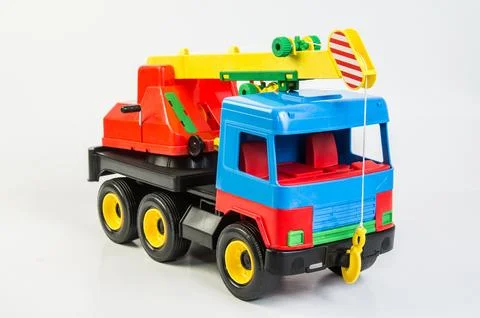 Multi-colored plastic toy trucks for children's games on a white background.. Fotos de archivo