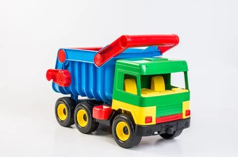 Multi-colored plastic toy trucks for children's games on a white background.. Foto stock