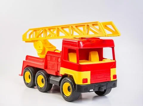 Multi-colored plastic toy trucks for children's games on a white background.. Foto stock