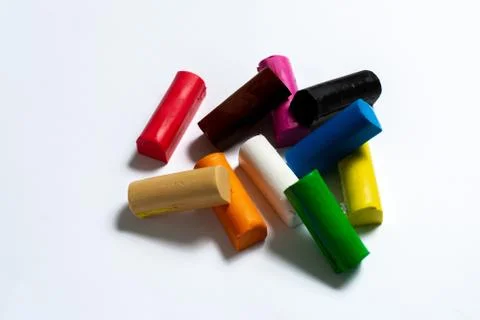 Multi-colored plasticine cubes lie a bunch on a white background. Foto stock