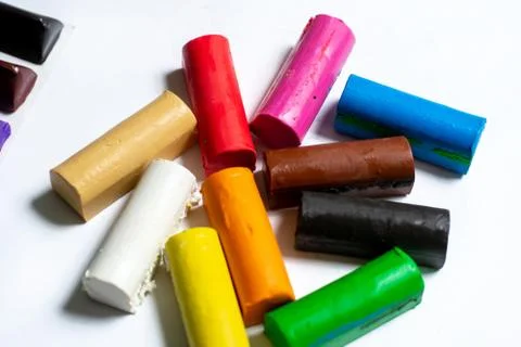 Multi-colored plasticine cubes lie a bunch on a white background. Foto stock