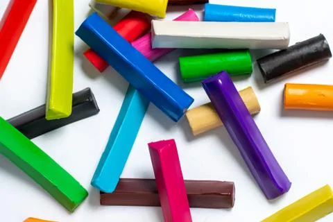 Multi-colored plasticine cubes lie a bunch on a white background. Foto stock