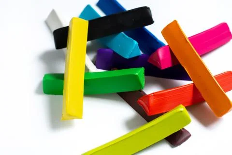 Multi-colored plasticine cubes lie a bunch on a white background. isolate. Stock Photos
