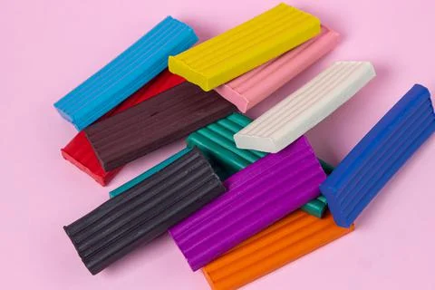 Multi-colored plasticine on a pink background. Educational game.  Stock Photos