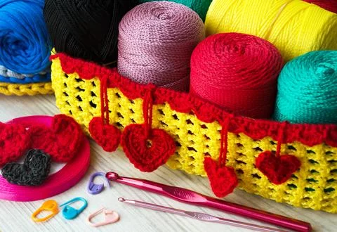 Multi-colored polyester rolls in a wicker basket. Stock Photos