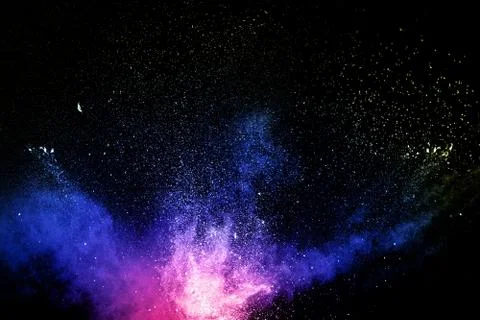 Multi colored powder explosion  on black background.Colorful dust splash. Stock Photos