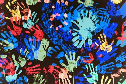 Multi-colored prints of hands smeared with paint on a black wall Stock Illustration