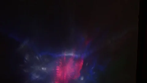 Multi-colored rays of light move randomly on a dark background Stock-Footage 107469801