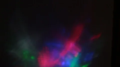Multi-colored rays of light move randomly on a dark background Stock-Footage 107469840