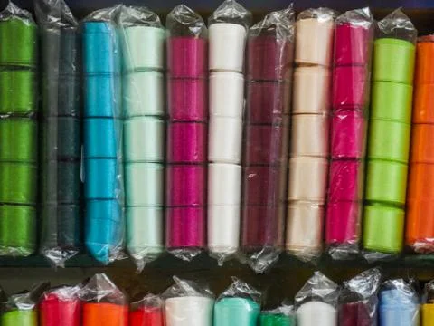 Multi-colored ribbon on the shelf. Textile shop. Sewing goods store. Stock Photos