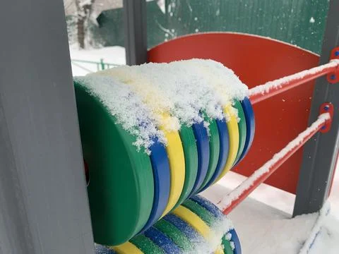 Multi-colored rings on the playground in winter. Stock Photos