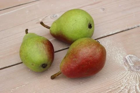 Multi-colored ripe pears on background of boards. Stock Photos