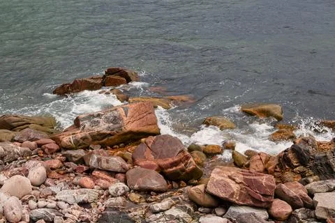 Multi-colored rocks along the Atlantic coastline in Nova Scotia, Canada. Stock Photos