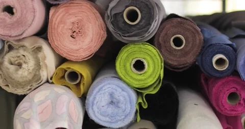 Multi-colored rolls of fabric on a shelf in a store. Stock Footage 157356816