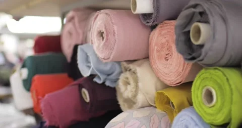 Multi-colored rolls of textile on a shelf in a shop. Stock Footage 157324134