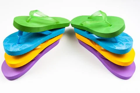 Multi-colored rubber beach flip flops on a white background Stock Photos