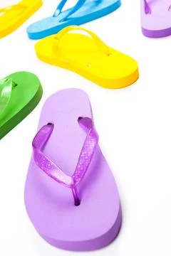 Multi-colored rubber beach flip flops on a white background Stock Photos
