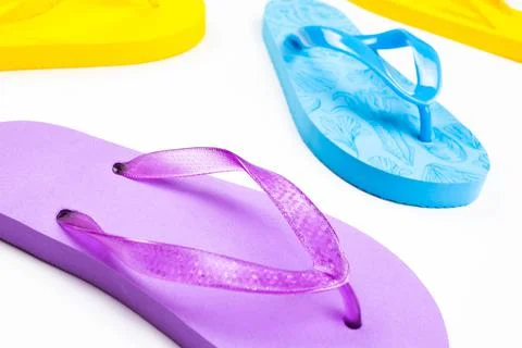 Multi-colored rubber beach flip flops on a white background Stock Photos
