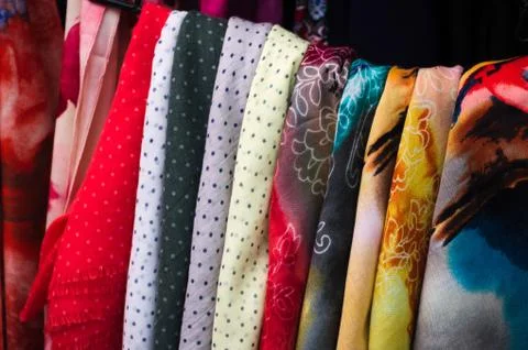 Multi-colored scarves hung in the store Stock Photos