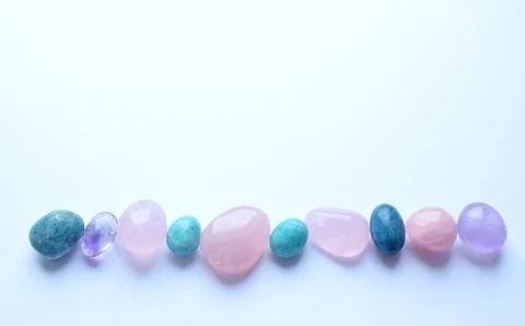 Multi-colored semi-precious round stones of rose quartz, kyanite and amazon.. Stock Photos