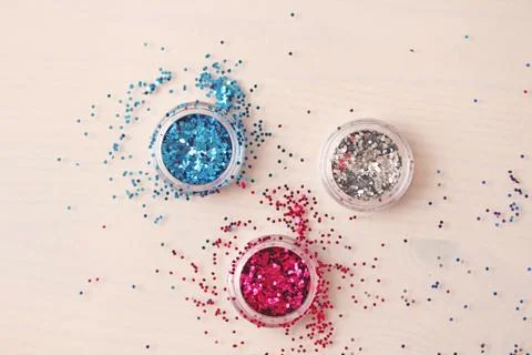 Multi-colored Sequins for the design of nails in a box. Glitter in jars. Stock Photos