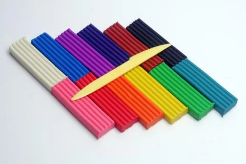 Multi-colored set of plasticine sticks and sculptural knife on white 스톡 사진