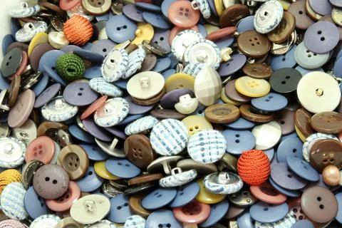 Multi-colored sewing buttons of different sizes and shapes background Stock Photos