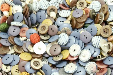 Multi-colored sewing buttons of different sizes and shapes background Stock Photos