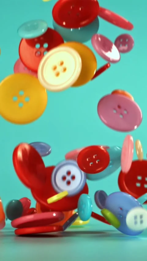 Multi-colored sewing buttons fall on the table. Filmed on a high-speed camera at Stock Footage 335369392