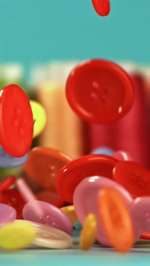 Multi-colored sewing buttons fall on the table. Filmed on a high-speed camera at Stock Footage 335373359