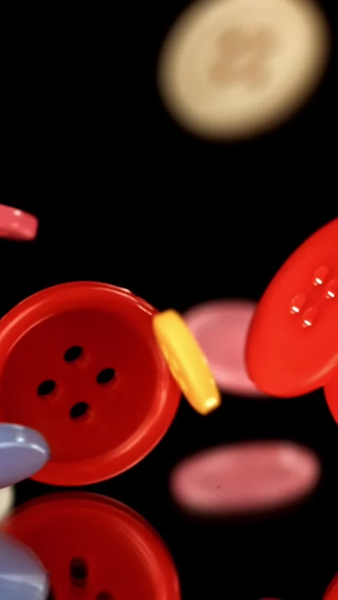 Multi-colored sewing buttons fall on the table. Filmed on a high-speed camera at Stock Footage 335378095