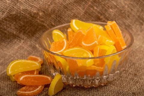Multi-colored shaped marmalade lemon slices in a glass vase, close-up, select Stock Photos