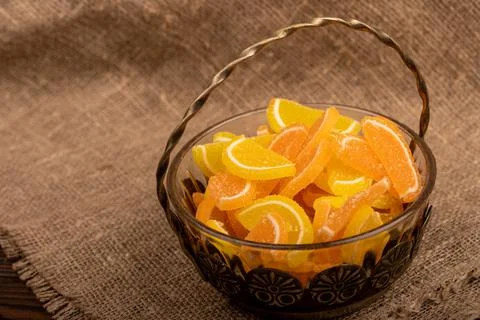 Multi-colored shaped marmalade lemon slices in a vintage vase, close-up, sele Stock Photos