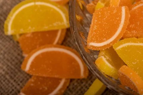 Multi-colored shaped marmalade lemon slices in a glass vase, close-up, select 写真素材