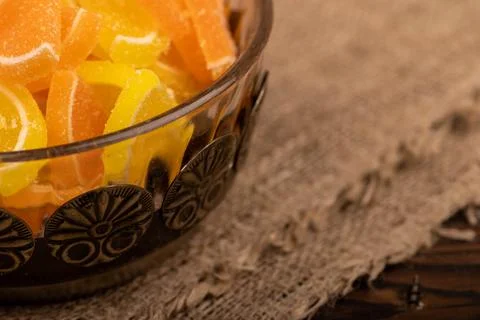 Multi-colored shaped marmalade lemon slices in a vintage vase, close-up, sele Stock Photos