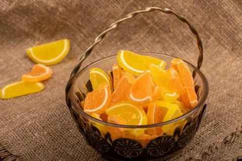 Multi-colored shaped marmalade lemon slices in a vintage vase, close-up, sele Stock Photos
