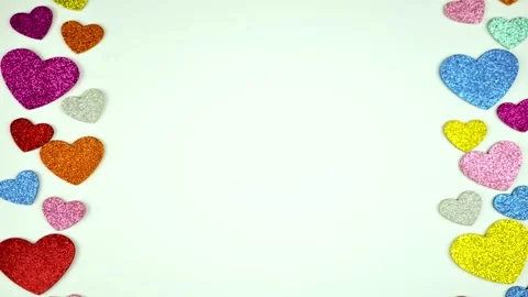 Multi-colored shiny hearts move from bottom to top on a white background Stock-Footage 212384087