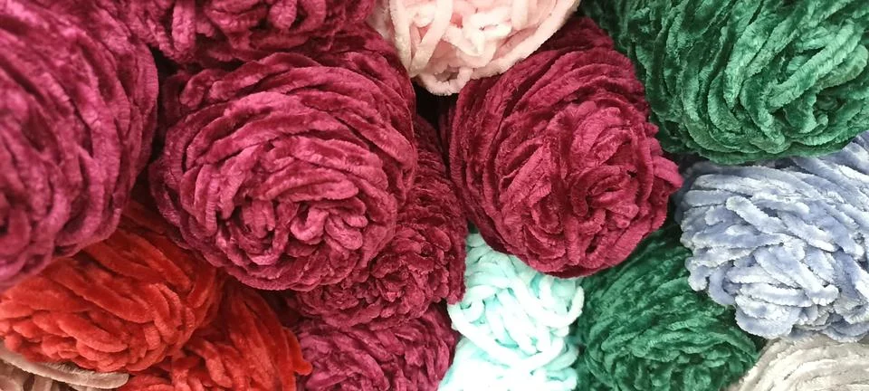 Multi-colored skeins of thread folded in a stack close-up Stock Photos