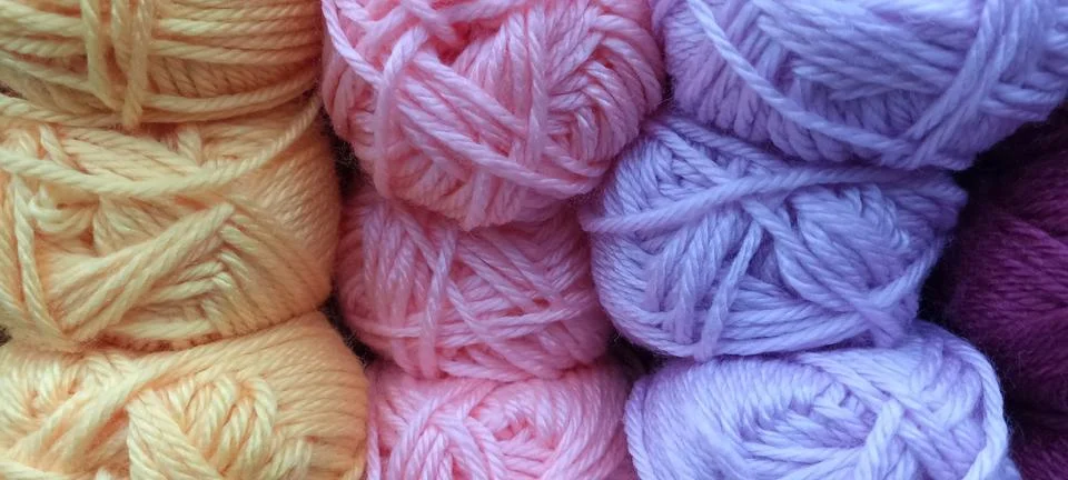 Multi-colored skeins of thread folded in a stack close-up Stock Photos
