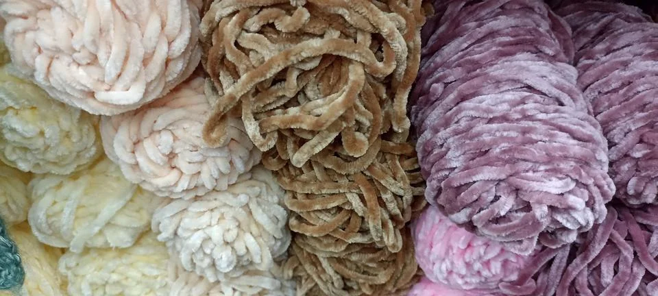 Multi-colored skeins of thread folded in a stack close-up Stock Photos