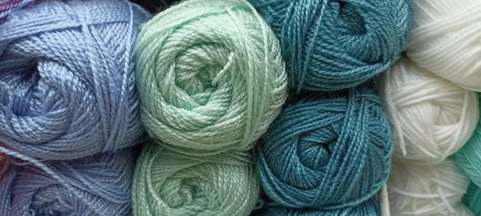 Multi-colored skeins of thread folded in a stack close-up Stock Photos